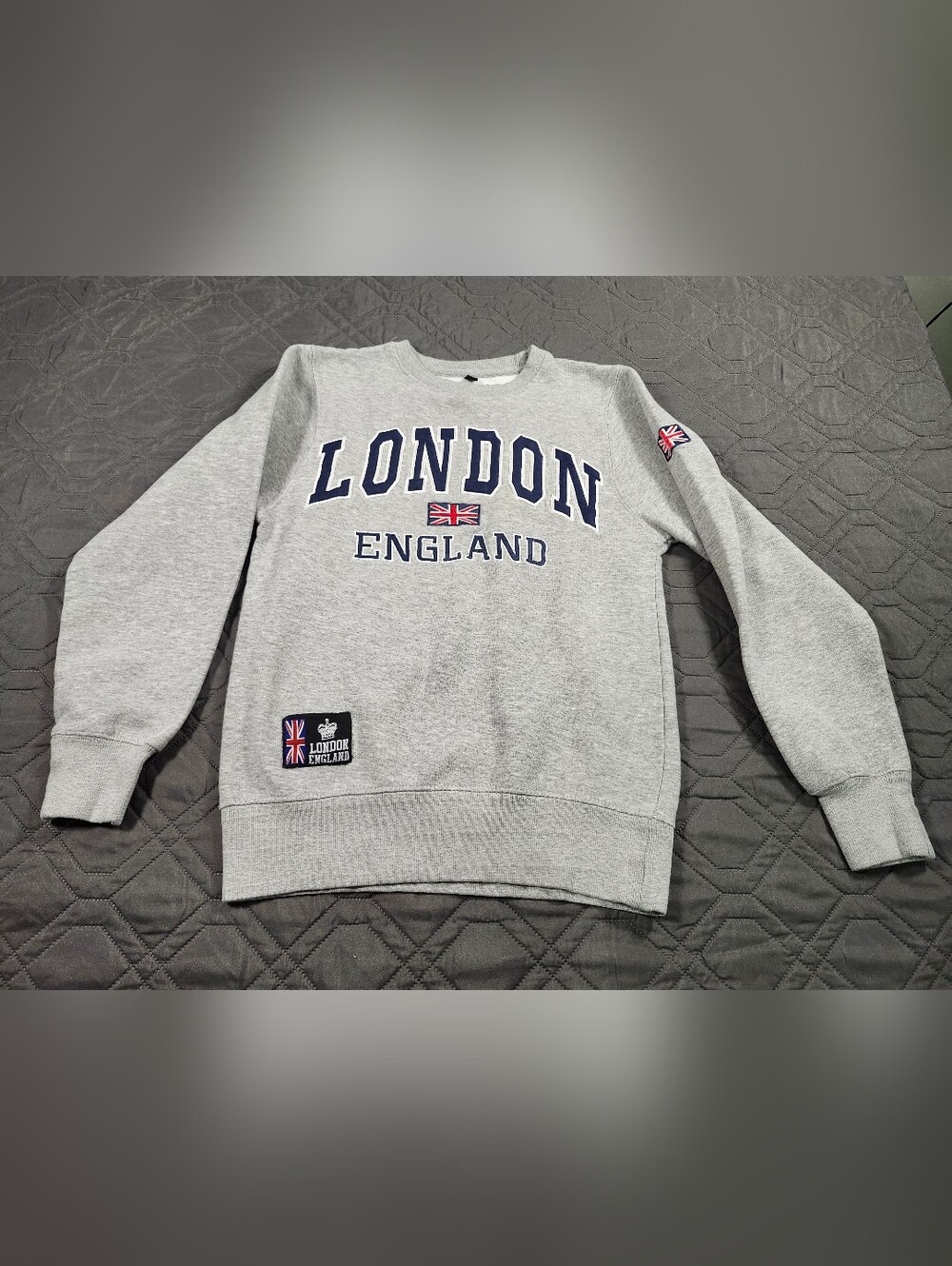 grey "London England" crewneck sweatshirt features embroidered lettering